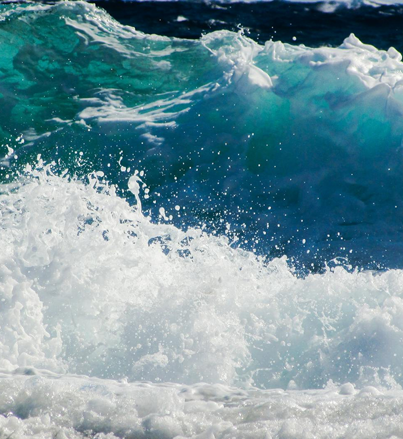 Cresting turquoise ocean waves with white sea foam representing emotional turbulence and anxiety