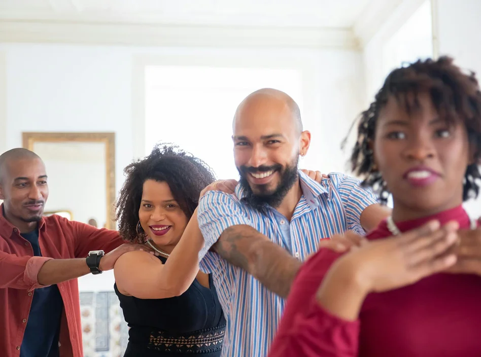 A diverse group of adults participating in a supportive group therapy session and wellness activity.