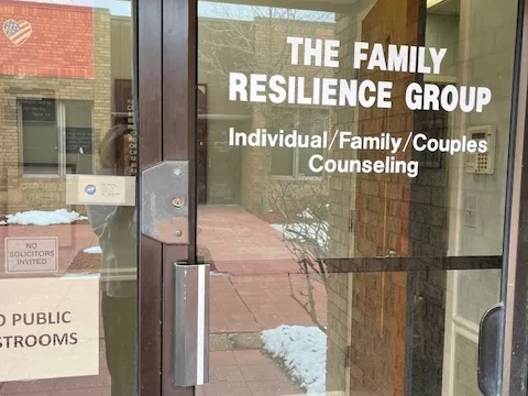 A decorative 'Be Present' sign next to a small succulent on a white shelf, reflecting our office environment and mindful approach.