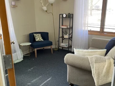 A decorative 'Be Present' sign next to a small succulent on a white shelf, reflecting our office environment and mindful approach.